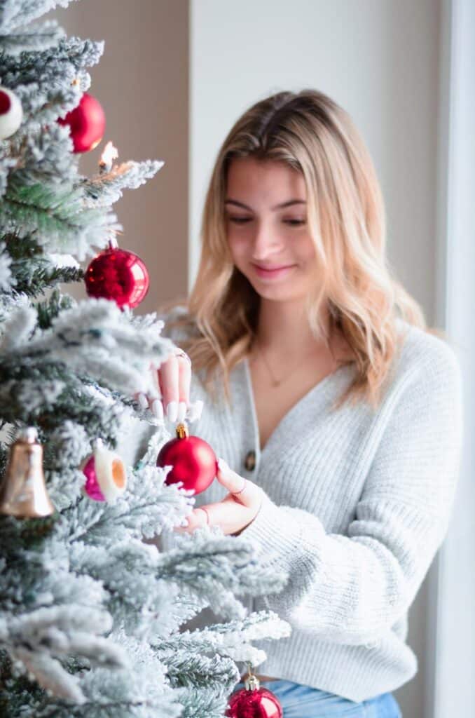 EnglishGardensGirlDecoratingFlockedArtificialChristmasTree